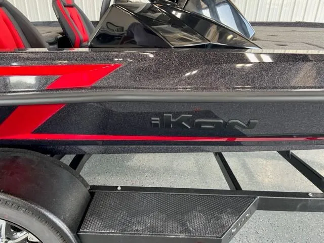 Slide: The Image of 2024 iKon LX21 boat with black and red design on trailer. - 27