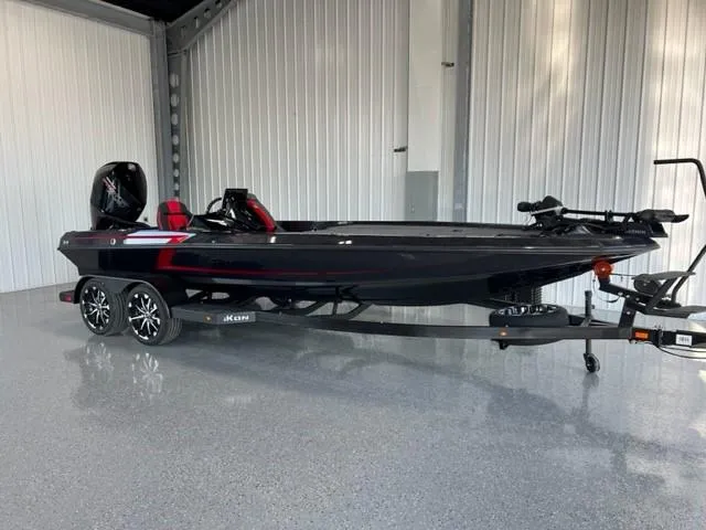 Slide: The Image of 2024 iKon LX21 black and red fishing boat on trailer in garage. - 3