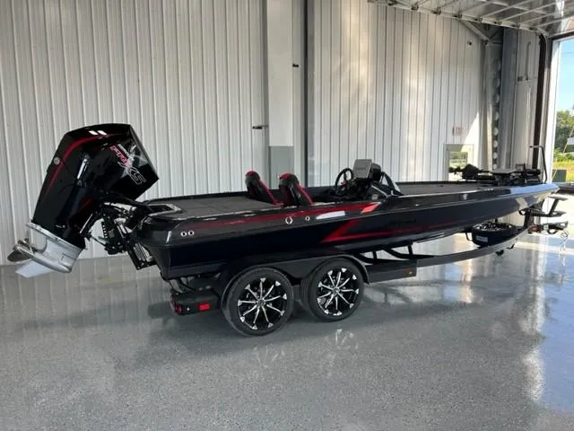 Slide: The Image of 2024 iKon LX21 black and red bass boat in a showroom. - 4