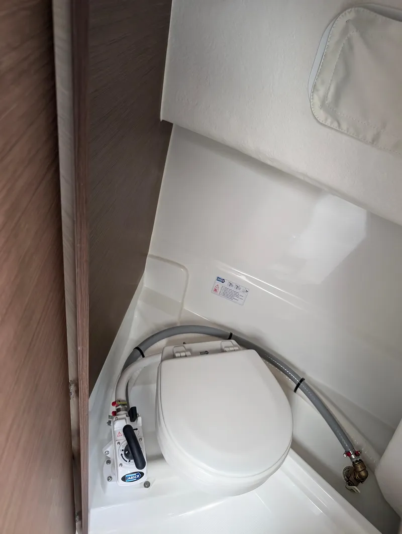 Slide: The Image of 2023 Jeanneau NC 695 Sport S2 boat interior toilet. - 12