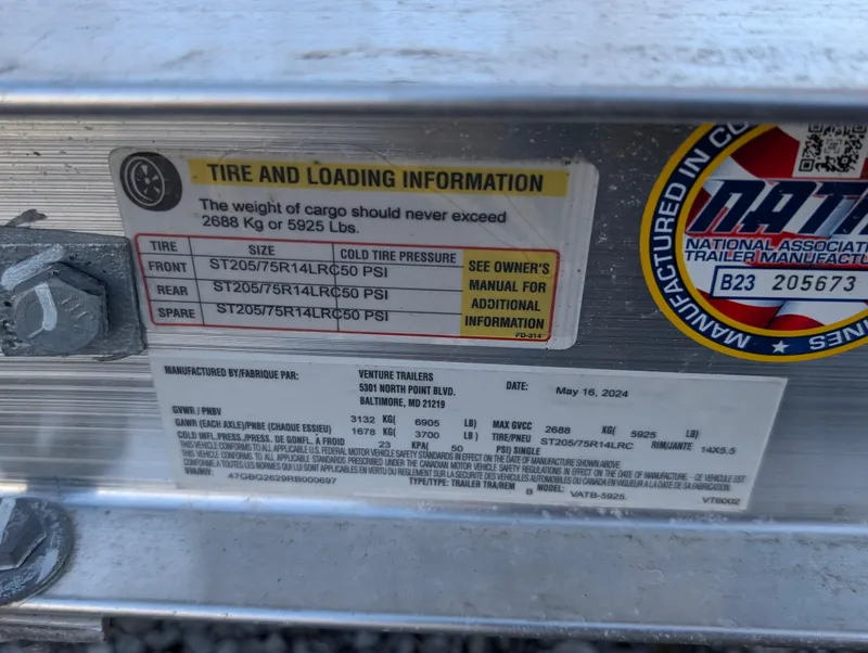 Slide: The Image of Tire and loading information label on a 2023 Jeanneau NC 695 Sport S2. - 13