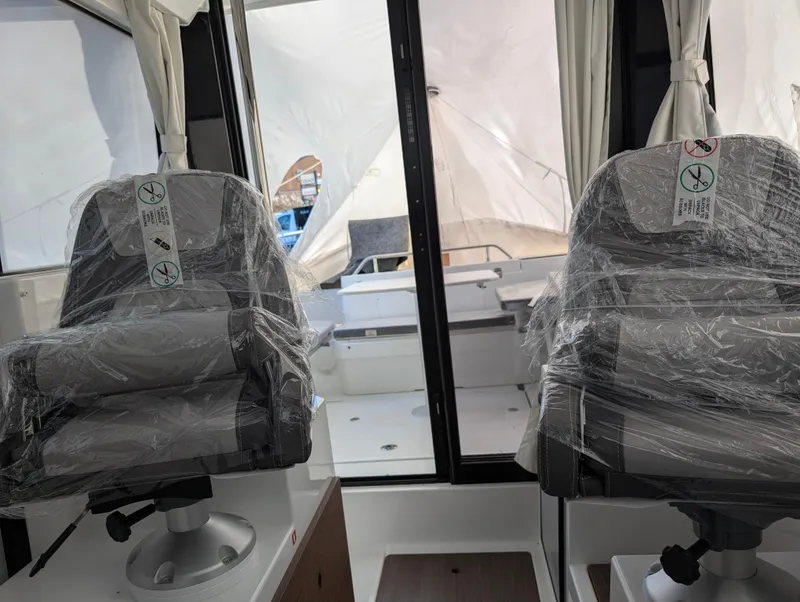 Slide: The Image of Interior of 2023 Jeanneau NC 695 Sport S2 boat with wrapped seats. - 2