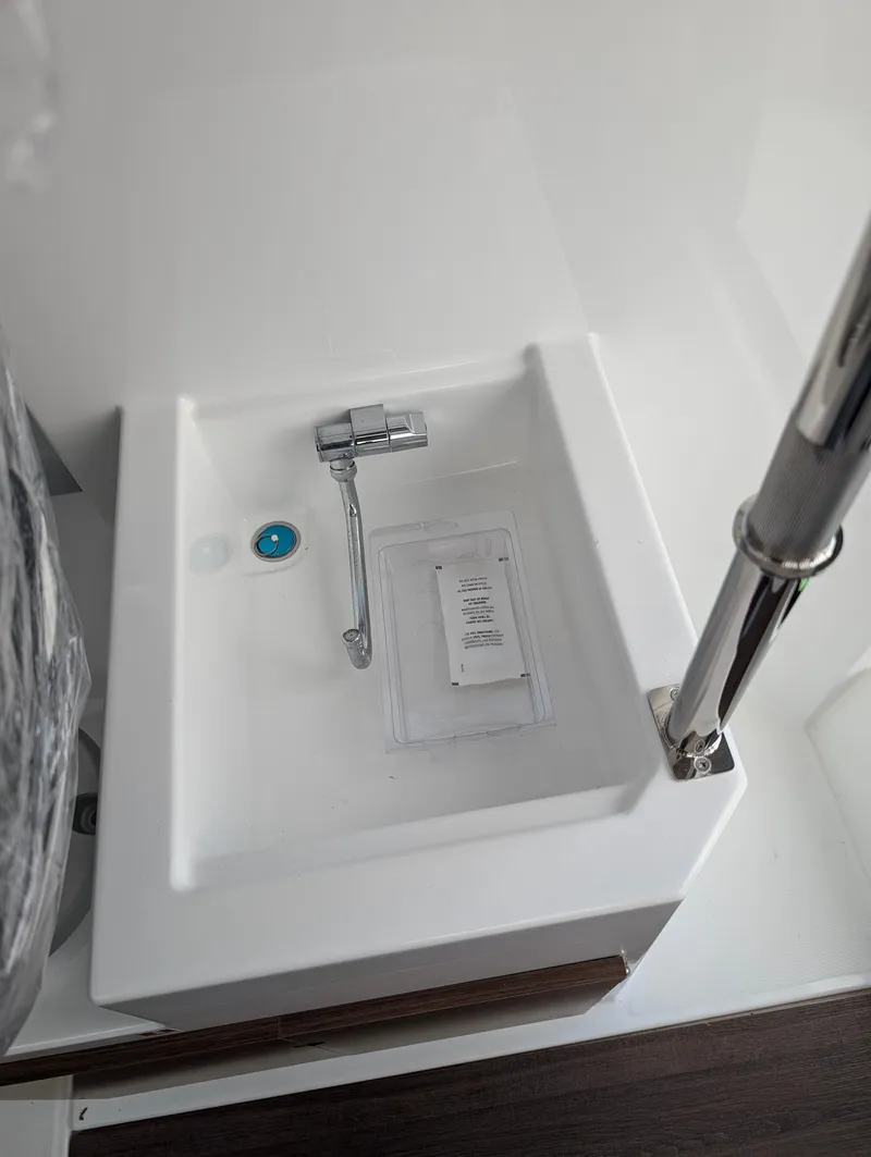 Slide: The Image of 2023 Jeanneau NC 695 Sport S2 boat sink with modern faucet. - 3