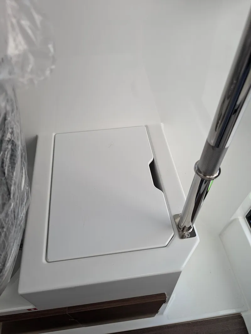 Slide: The Image of 2023 Jeanneau NC 695 Sport S2 boat interior detail with storage compartment. - 4