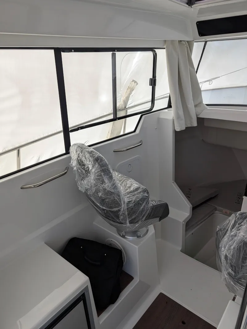 Slide: The Image of Interior of 2023 Jeanneau NC 695 Sport S2 boat with covered seating. - 8