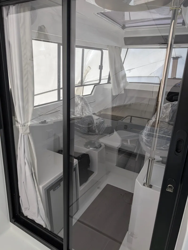 Slide: The Image of Interior view of 2023 Jeanneau NC 695 Sport S2 boat, featuring modern design and seating. - 9