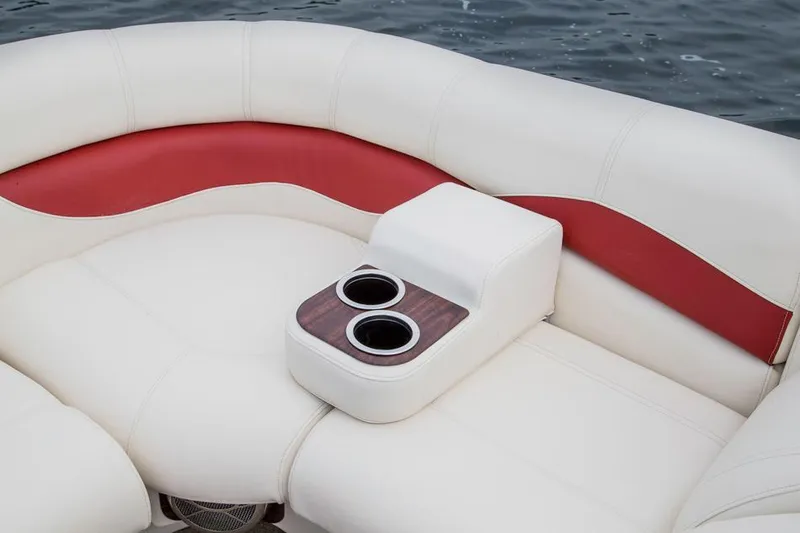 Slide: The Image of 2015 AquaPatio 240 SLR boat interior with white and red seating and cup holders. - 19