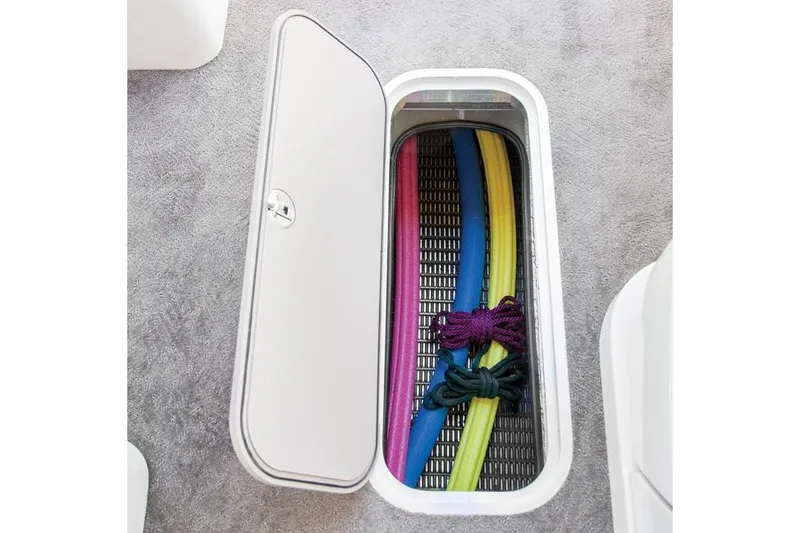 Slide: The Image of 2015 AquaPatio 240 SLR storage compartment with colorful pool noodles and ropes. - 20