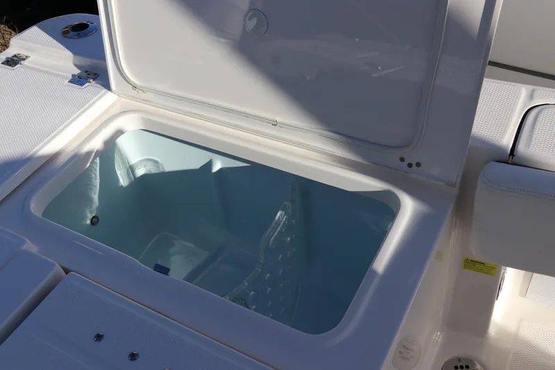 Slide: The Image of 2024 Robalo 266 Cayman boat storage compartment with open lid. - 14