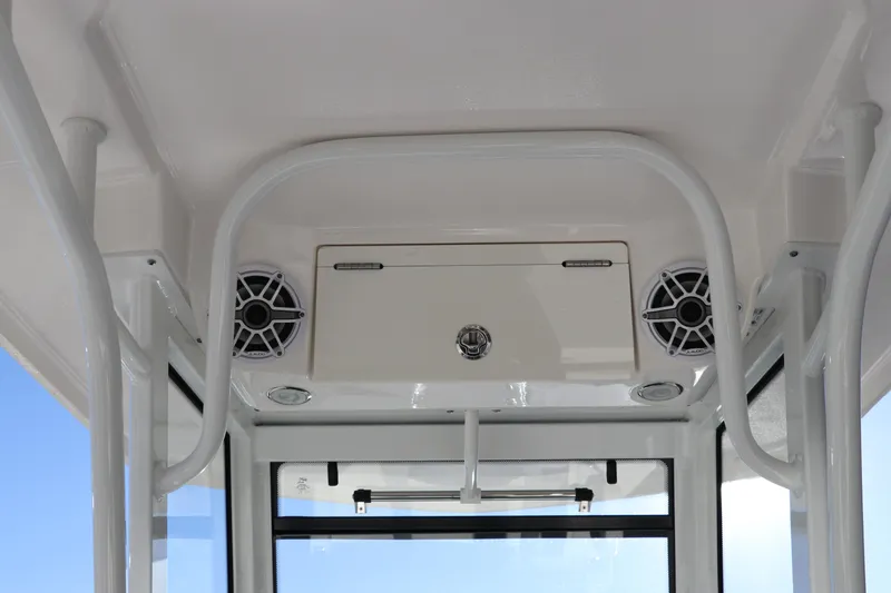 Slide: The Image of 2024 Robalo 266 Cayman boat interior with speakers and storage compartment. - 20
