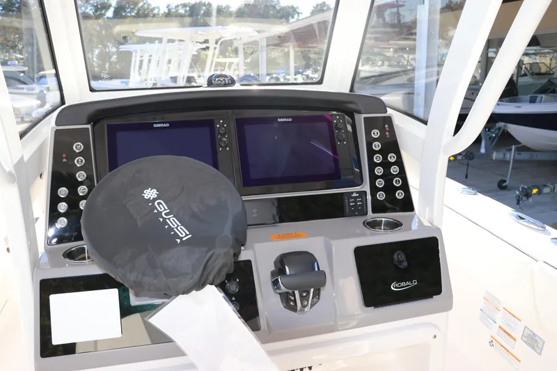 Slide: The Image of 2024 Robalo 266 Cayman boat dashboard with dual screens and controls. - 23