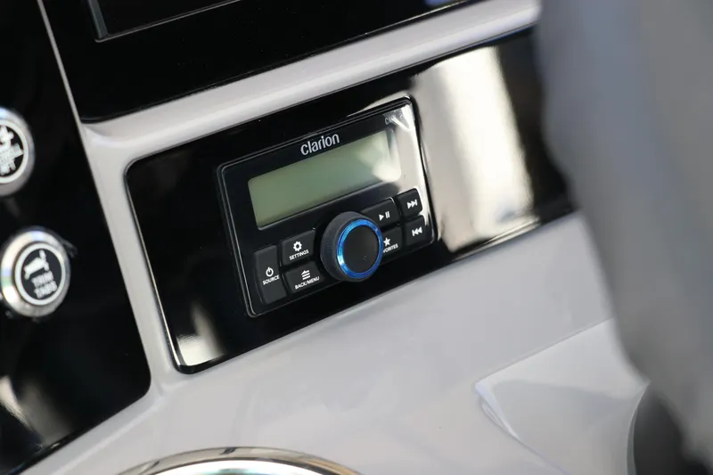 Slide: The Image of Clarion audio system on 2024 Robalo 266 Cayman boat dashboard. - 26