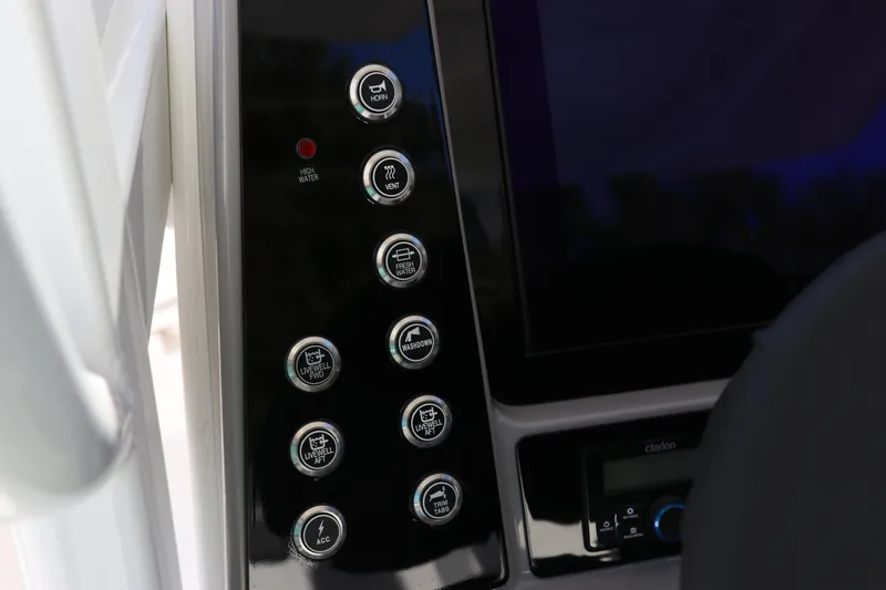 Slide: The Image of Control panel of 2024 Robalo 266 Cayman boat with various function buttons. - 27