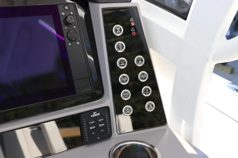 Slide: The Image of Control panel of 2024 Robalo 266 Cayman boat with navigation and switch buttons. - 29