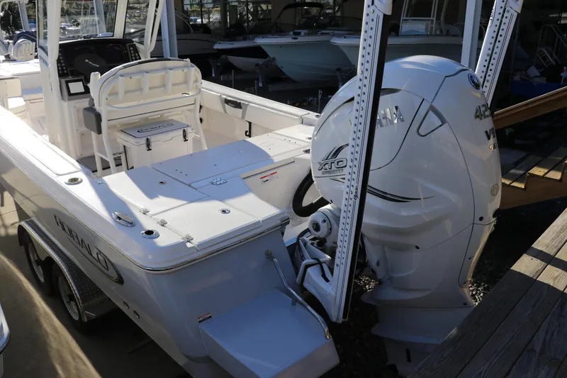 Slide: The Image of 2024 Robalo 266 Cayman boat with powerful Yamaha outboard engine, docked and ready for adventure. - 3