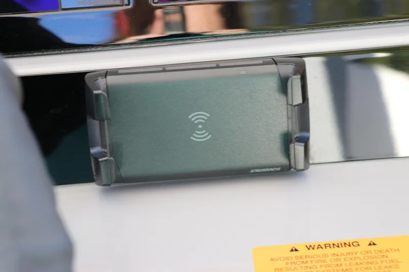 Slide: The Image of Wireless charging pad on 2024 Robalo 266 Cayman boat dashboard. - 33