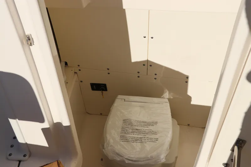 Slide: The Image of 2024 Robalo 266 Cayman boat interior with covered toilet. - 39