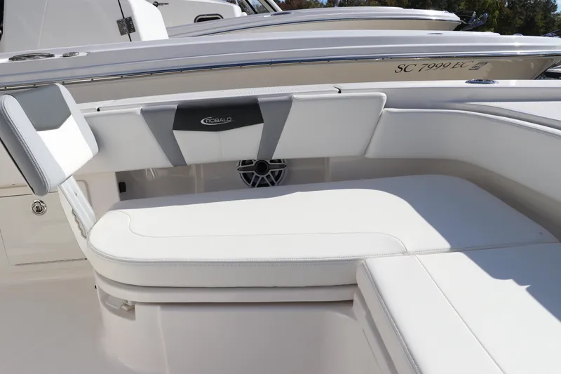 Slide: The Image of 2024 Robalo 266 Cayman boat interior with white cushioned seating. - 44