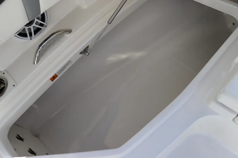 Slide: The Image of 2024 Robalo 266 Cayman boat storage compartment with sleek white interior. - 45