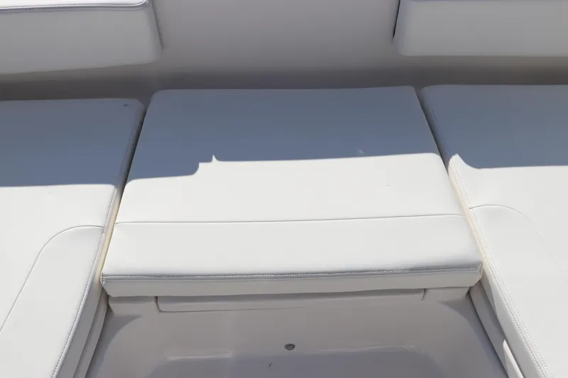 Slide: The Image of 2024 Robalo 266 Cayman boat seating area with white cushions. - 46