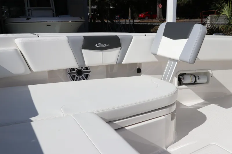 Slide: The Image of 2024 Robalo 266 Cayman boat interior with white seating and speaker. - 47