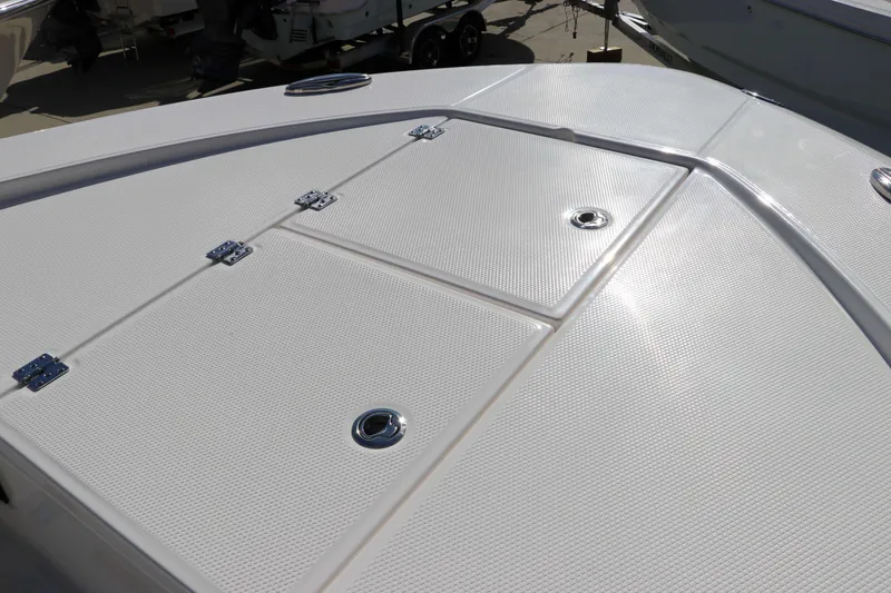 Slide: The Image of 2024 Robalo 266 Cayman boat deck with storage compartments and sleek design. - 49