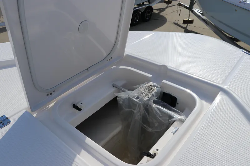Slide: The Image of 2024 Robalo 266 Cayman storage compartment with open hatch on deck. - 51