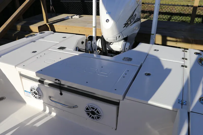 Slide: The Image of 2024 Robalo 266 Cayman boat deck with motor and storage compartments. - 7
