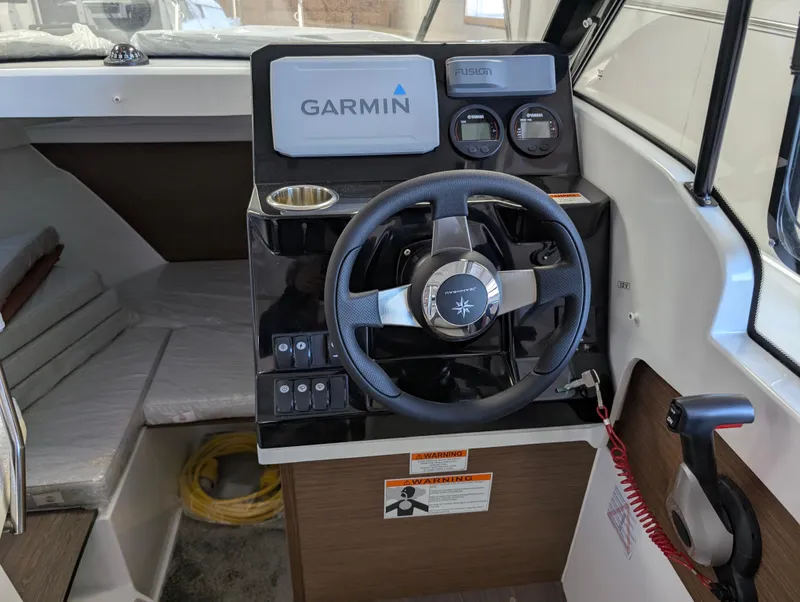 Slide: The Image of 2024 Jeanneau NC 695 Series 2 boat cockpit with Garmin navigation system. - 6