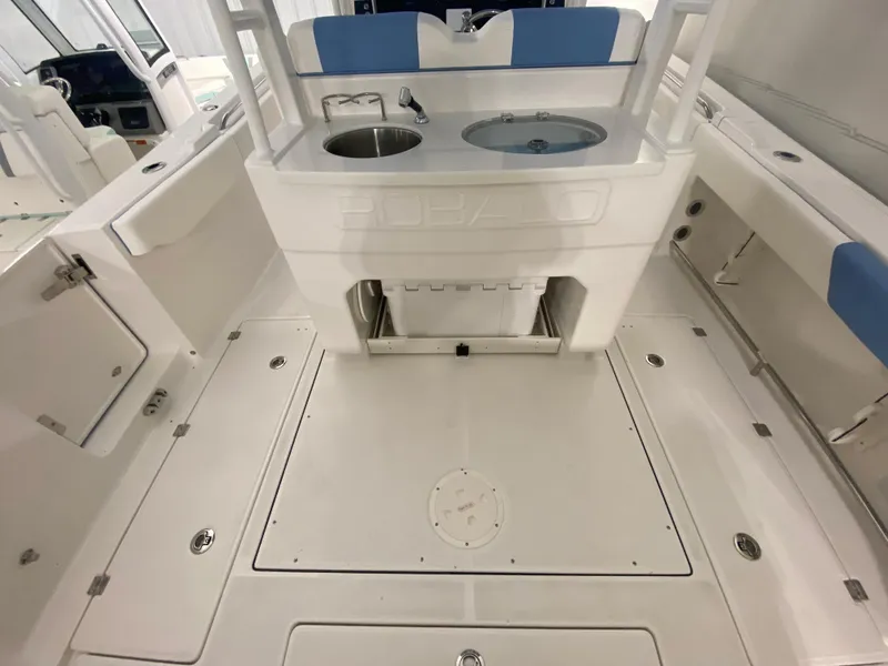 Slide: The Image of 2024 Robalo R302 boat interior with sink and storage compartments. - 12