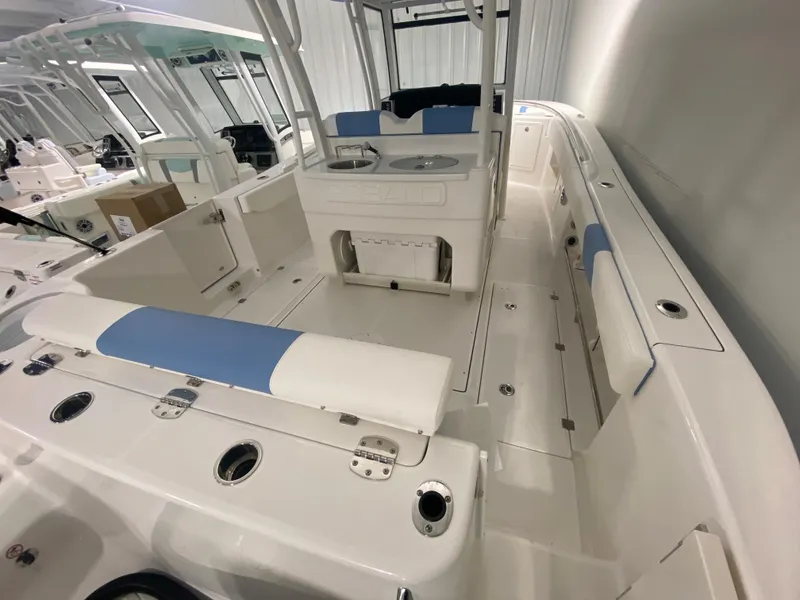 Slide: The Image of 2024 Robalo R302 boat interior with white and blue seating. - 31