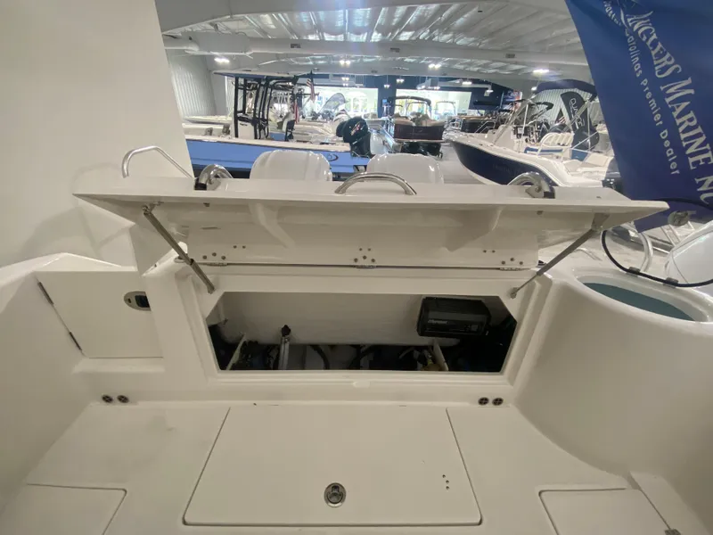 Slide: The Image of 2024 Robalo R302 boat storage compartment open in showroom. - 34