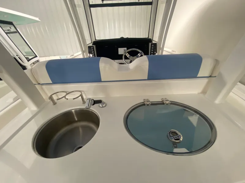 Slide: The Image of 2024 Robalo R302 boat interior with sink and covered compartment. - 41