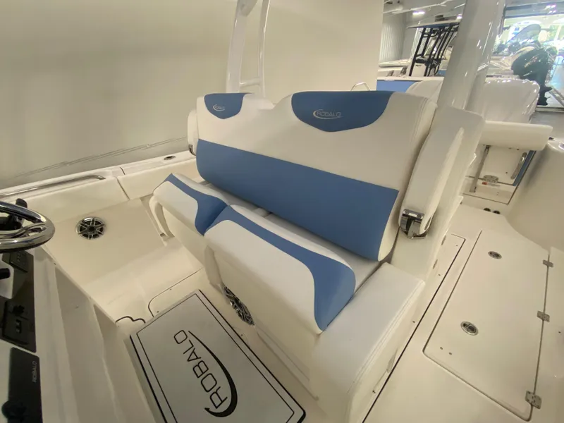 Slide: The Image of 2024 Robalo R302 boat interior with blue and white seating. - 45