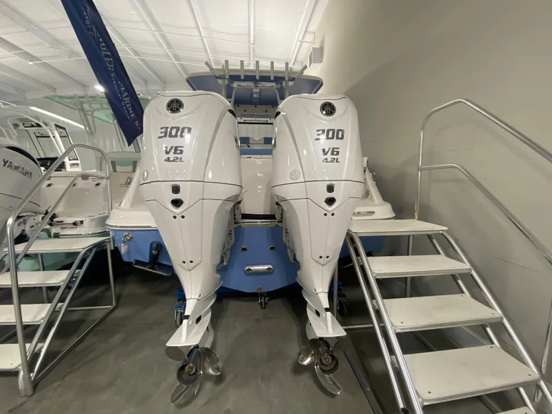 Slide: The Image of 2024 Robalo R302 boat with twin 300 V6 outboard engines in showroom. - 5
