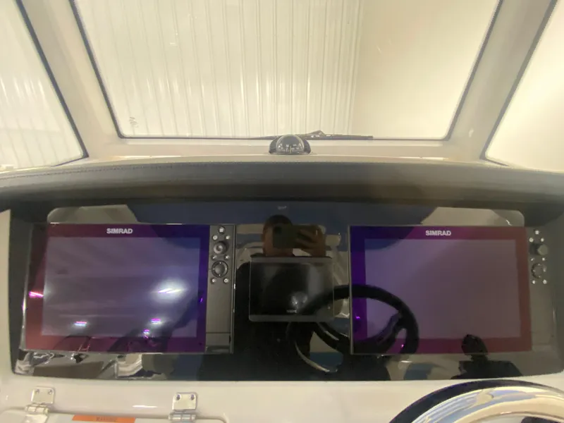 Slide: The Image of Dual Simrad displays on the 2024 Robalo R302 boat dashboard. - 24