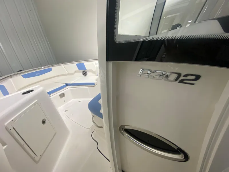 Slide: The Image of 2024 Robalo R302 boat interior with blue and white seating. - 26