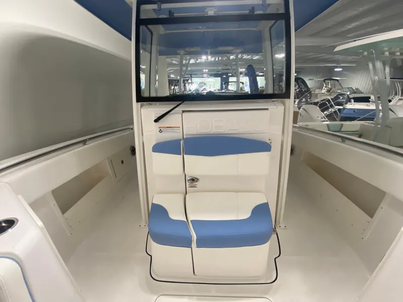 Slide: The Image of 2024 Robalo R302 boat interior with blue and white seating. - 30