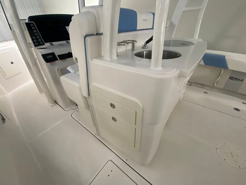 Slide: The Image of 2024 Robalo R302 boat interior with helm station and storage compartments. - 43