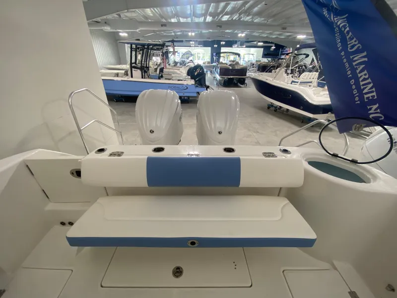 Slide: The Image of 2024 Robalo R302 boat interior with twin engines in showroom. - 8