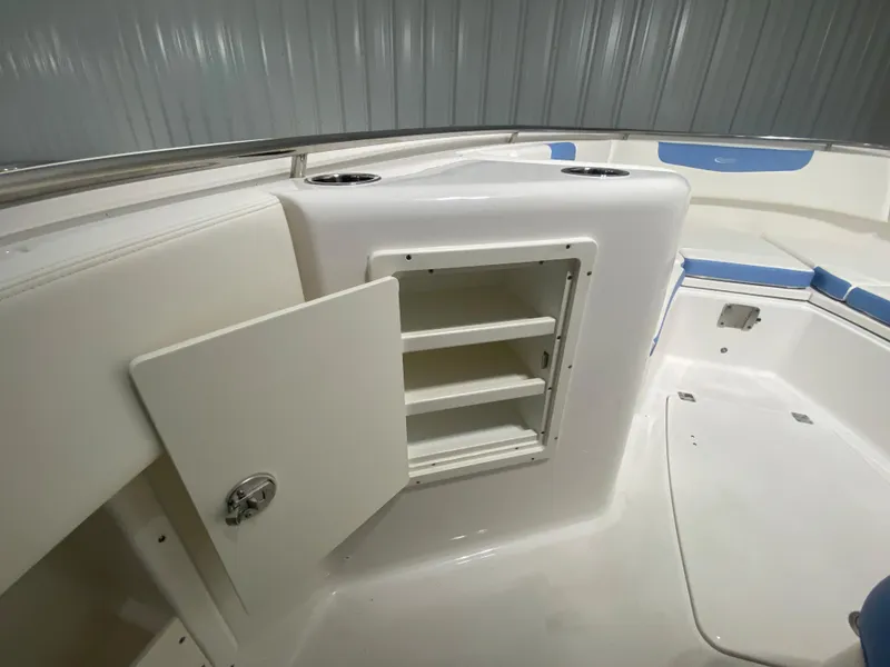 Slide: The Image of 2024 Robalo R302 boat interior storage compartment with open door. - 29