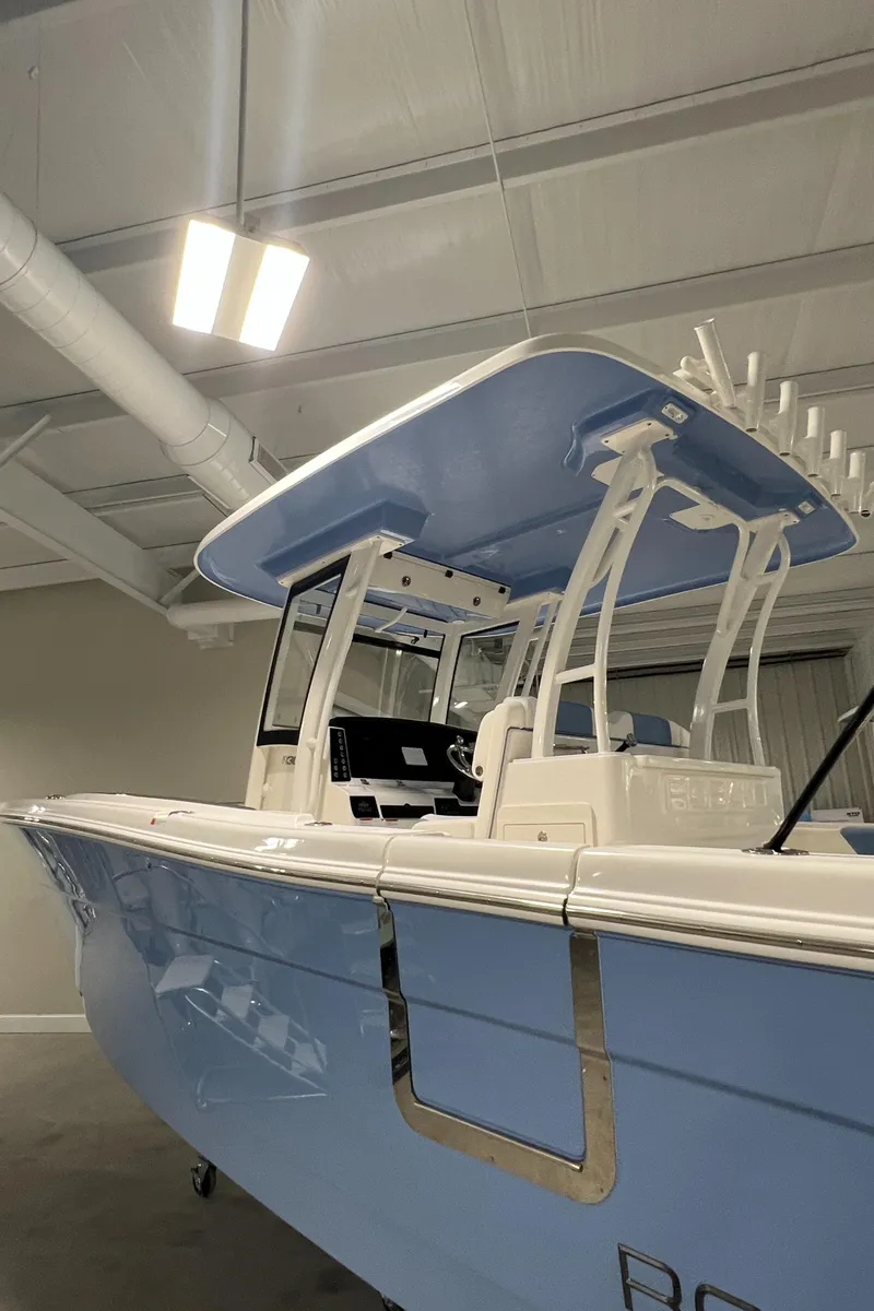 Slide: The Image of 2024 Robalo R302 boat in showroom, side view. - 3