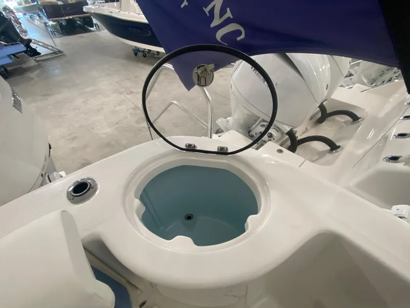 Slide: The Image of 2024 Robalo R302 boat livewell and seating area in showroom. - 35