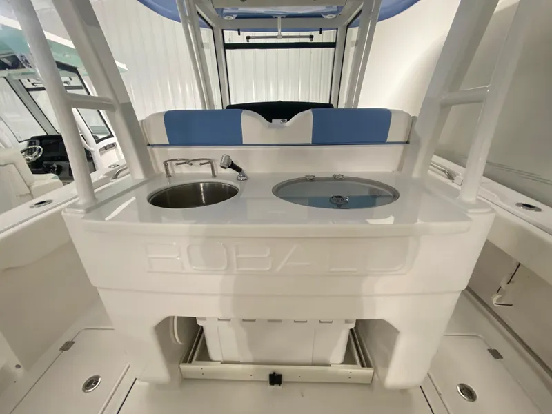 Slide: The Image of 2024 Robalo R302 boat interior with sink and storage compartments. - 39