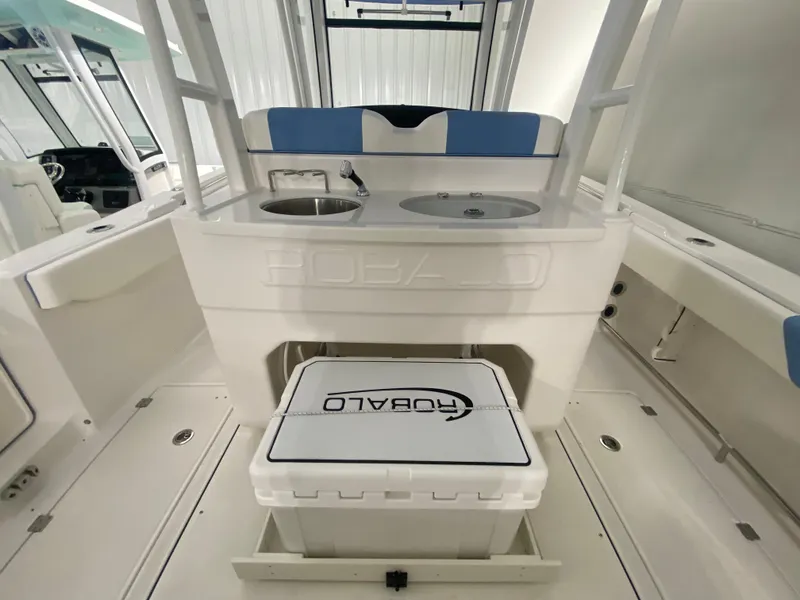 Slide: The Image of 2024 Robalo R302 boat interior with sink and cooler. - 40