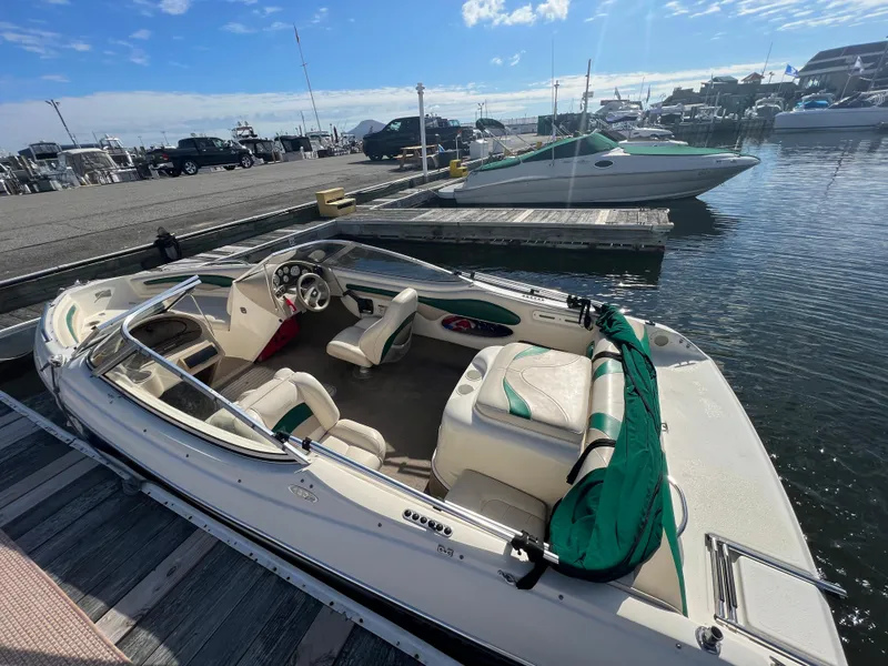 Slide: The Image of 2002 Stingray 180 LS/LX boat docked at a marina on a sunny day. - 12