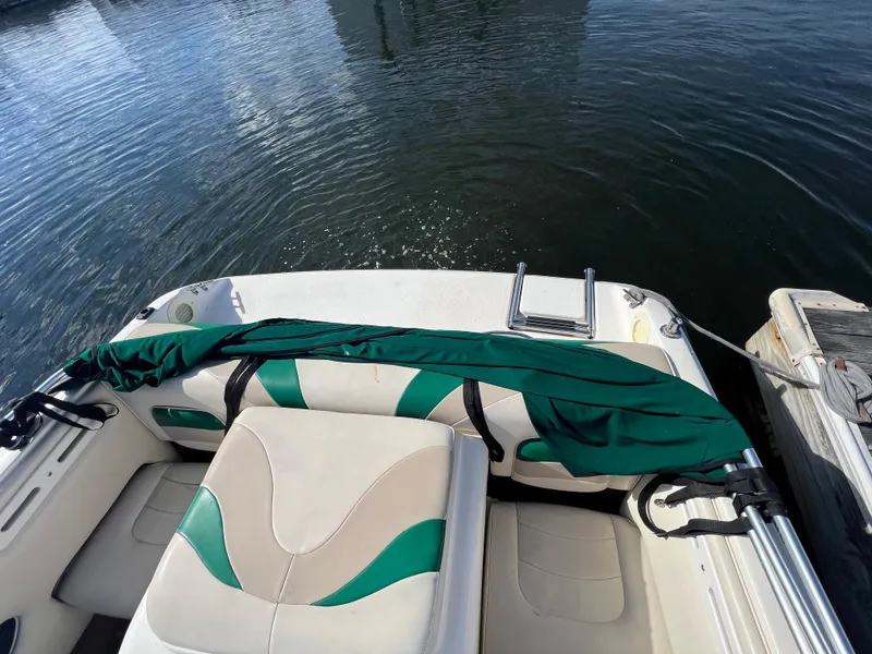 Slide: The Image of 2002 Stingray 180 LS/LX boat interior with green and white seating. - 6
