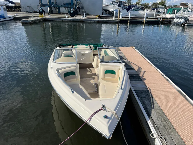 Slide: The Image of 2002 Stingray 180 LS/LX boat docked at a marina. - 7