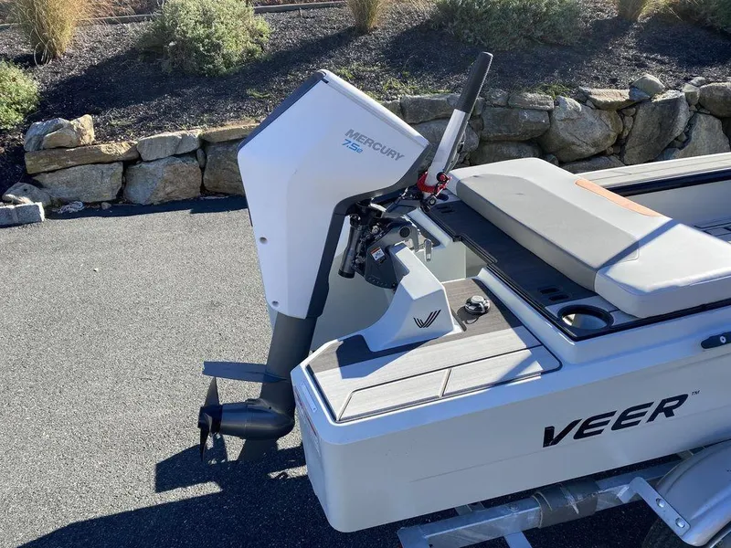 Slide: The Image of 2024 Veer V13 boat with Mercury engine, parked on pavement near stone wall. - 6