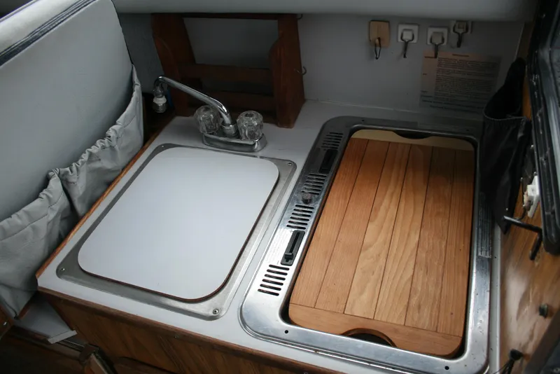 Slide: The Image of 1991 Olympic 23' Runabout boat kitchen sink and stove area. - 10
